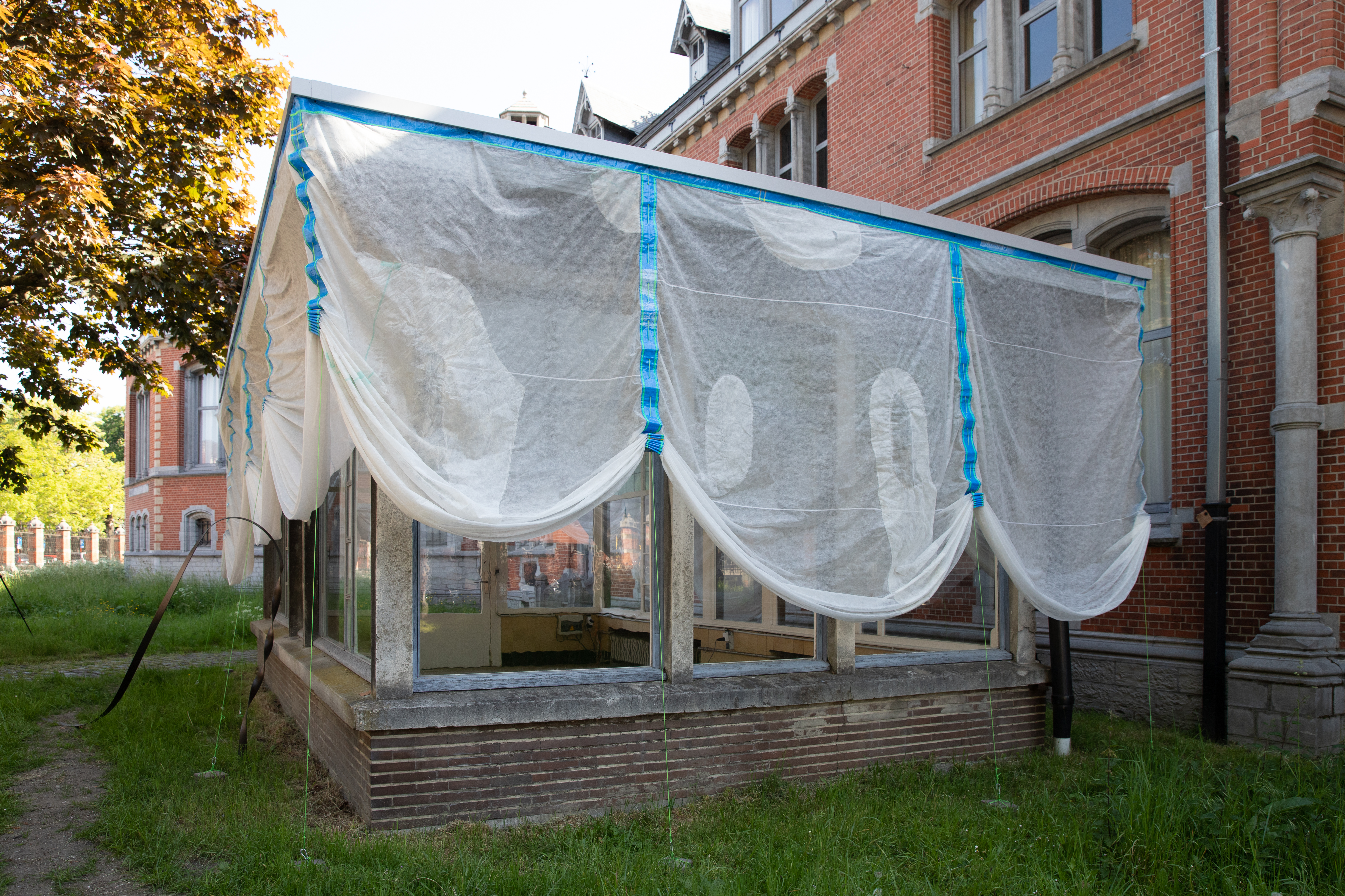 "Underbelly" overview of the drapery and patchwork made to repair areas damaged by the wind.